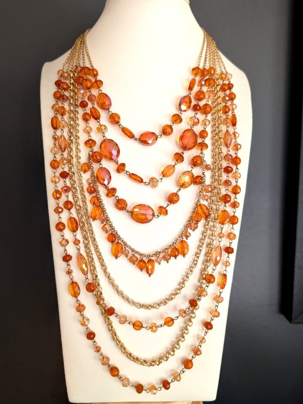 Multi strand layered gold chain and shades of orange beaded necklace